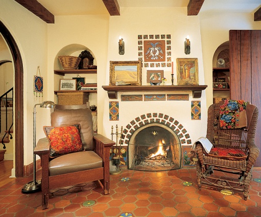 caption: Ronstadt's study,
nestled between the entrance hall and a guest room, features original tile work around
and above the fireplace. A Native American beaded bag hangs at left, near a signed
William Morris chair. The paintings on the mantel are by Maynard Dixon.